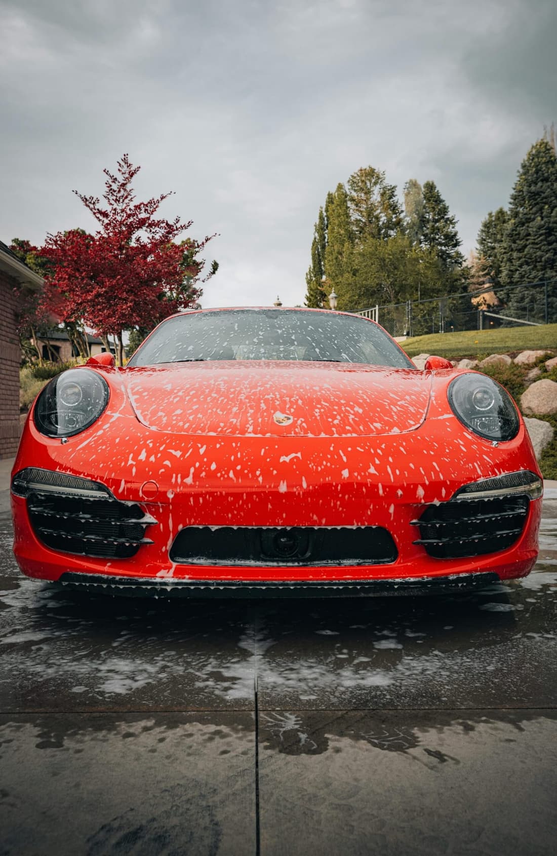 Red Porsche receiving premium mobile foam wash in West Plains MO by Premier Autos Detailing.