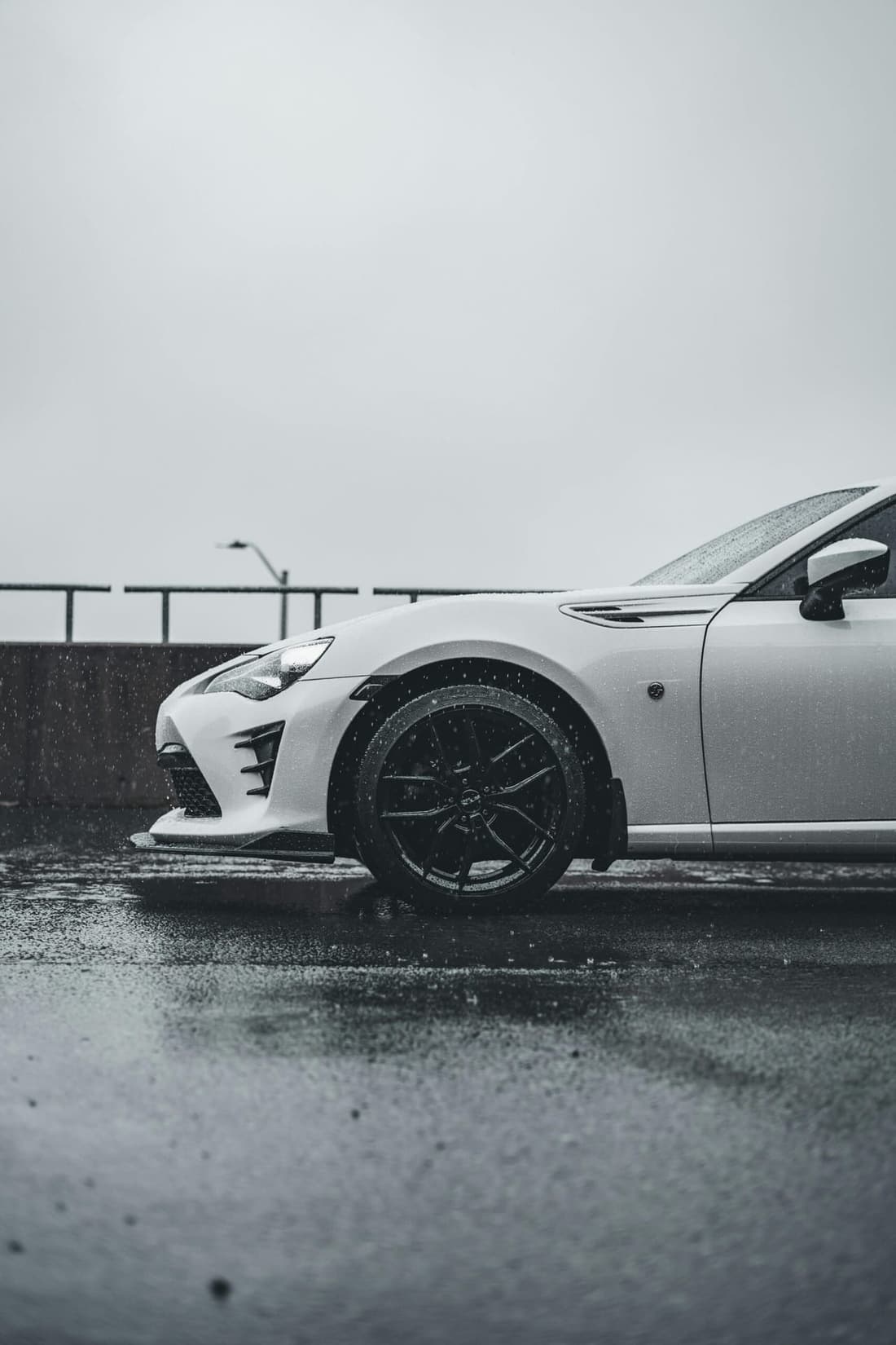 Subaru BRZ front half side view in spring rain showing car detailing