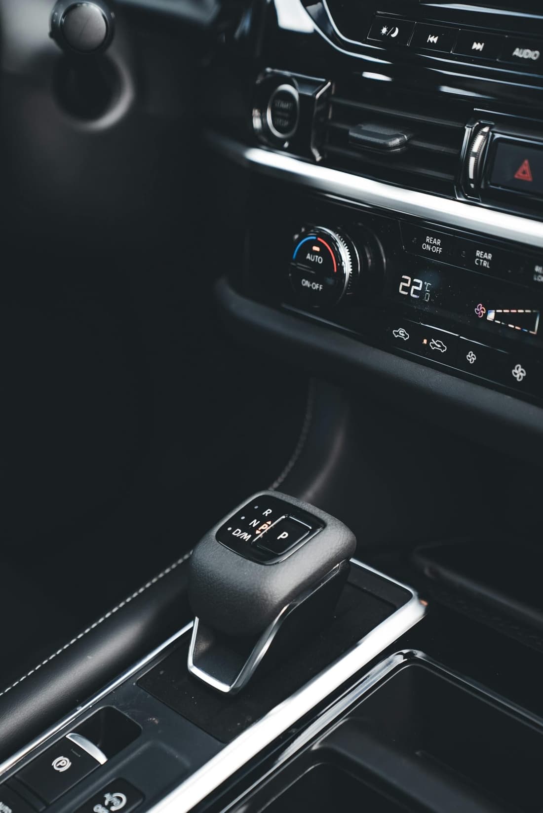 Clean and modern car interior featuring gear selector and digital climate controls