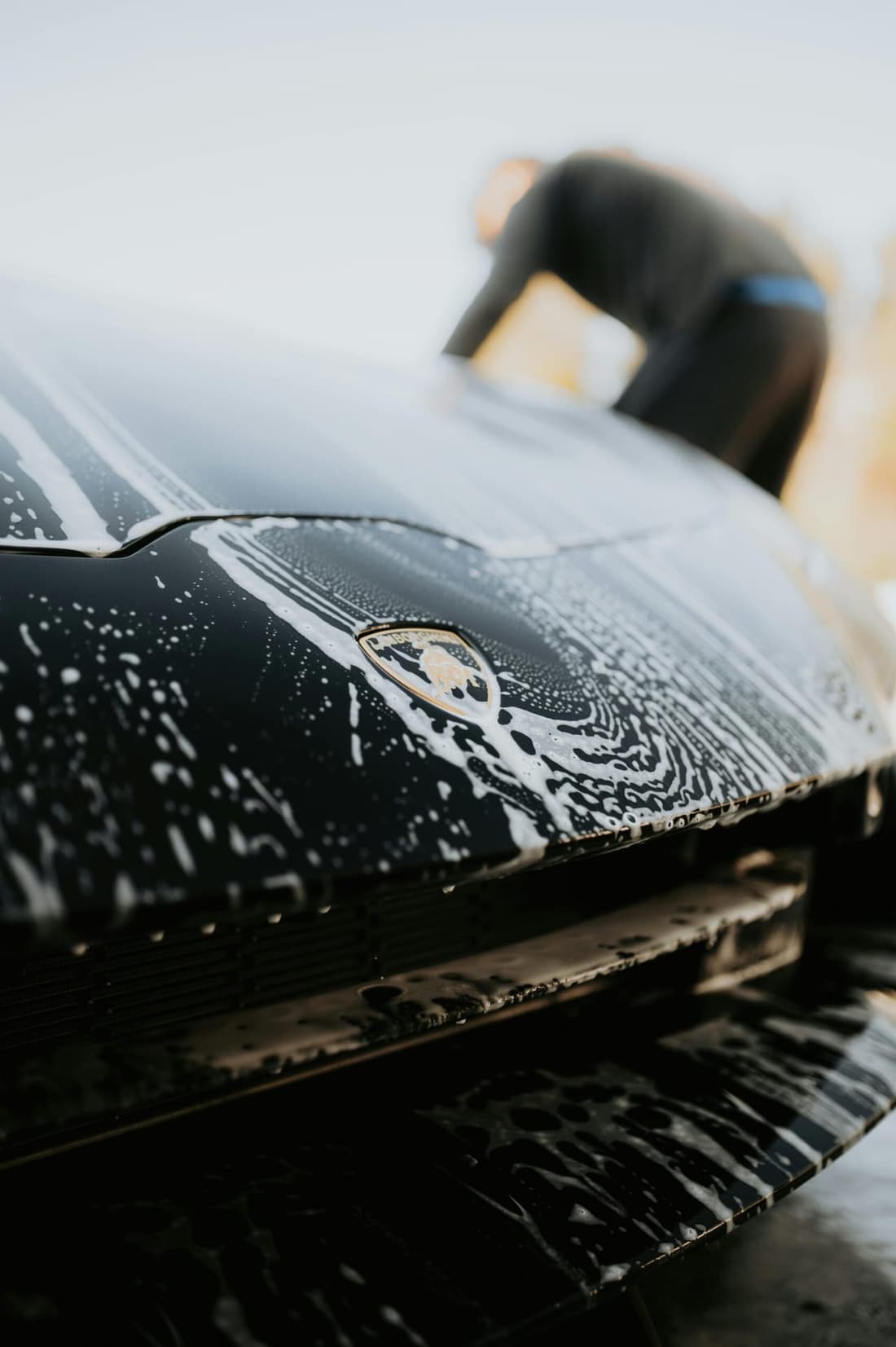 Luxury sports car being hand washed with soap suds during a full detailing service in West Plains, MO.