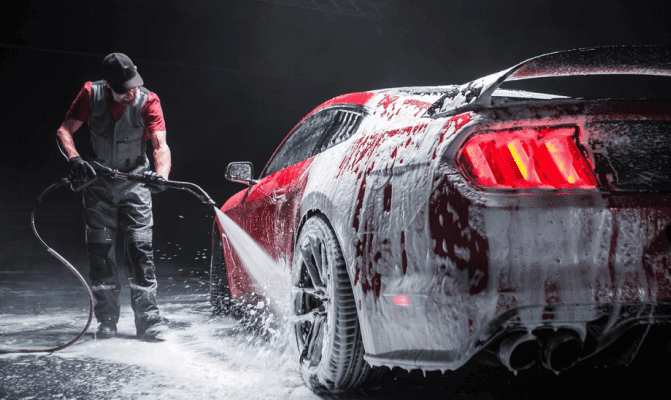 Detailer hand-washing a car