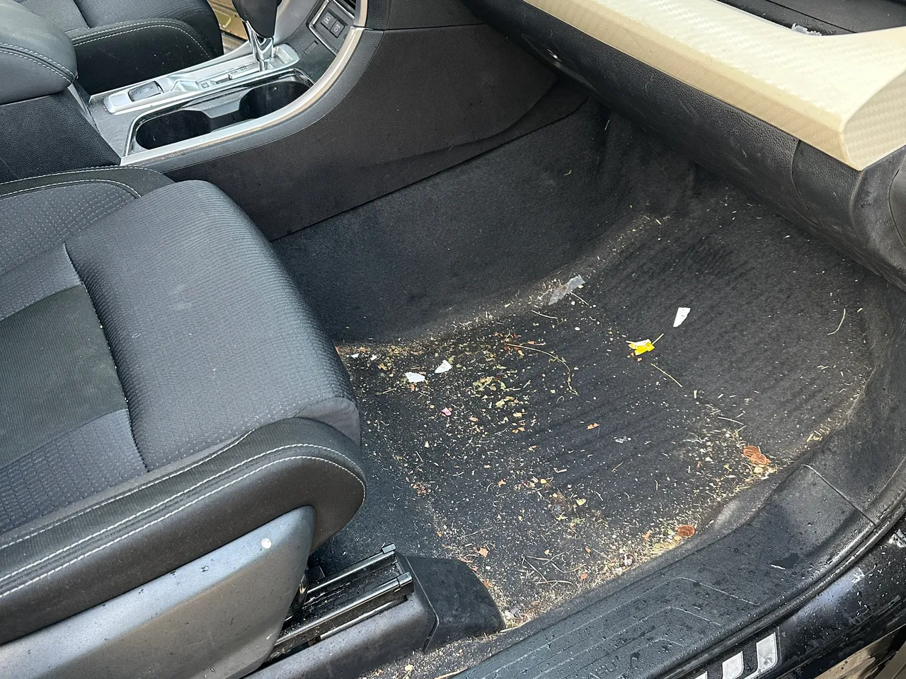 Before: Toyota Tacoma passenger footwell before and after interior detailing in West Plains, MO