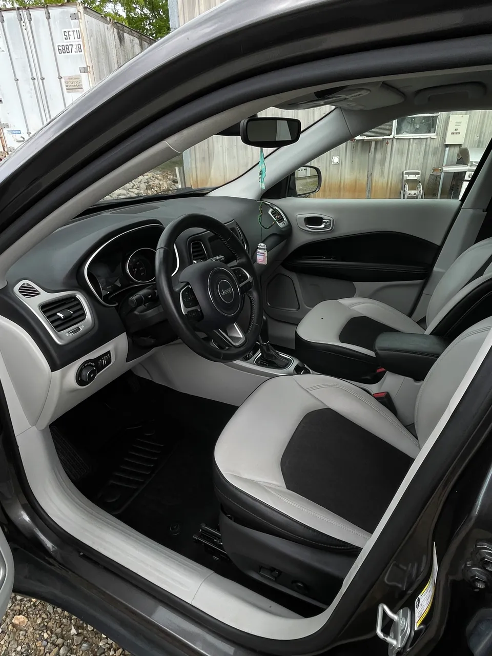 Detailed two-tone front seats and dashboard of a Jeep Compass in West Plains, MO