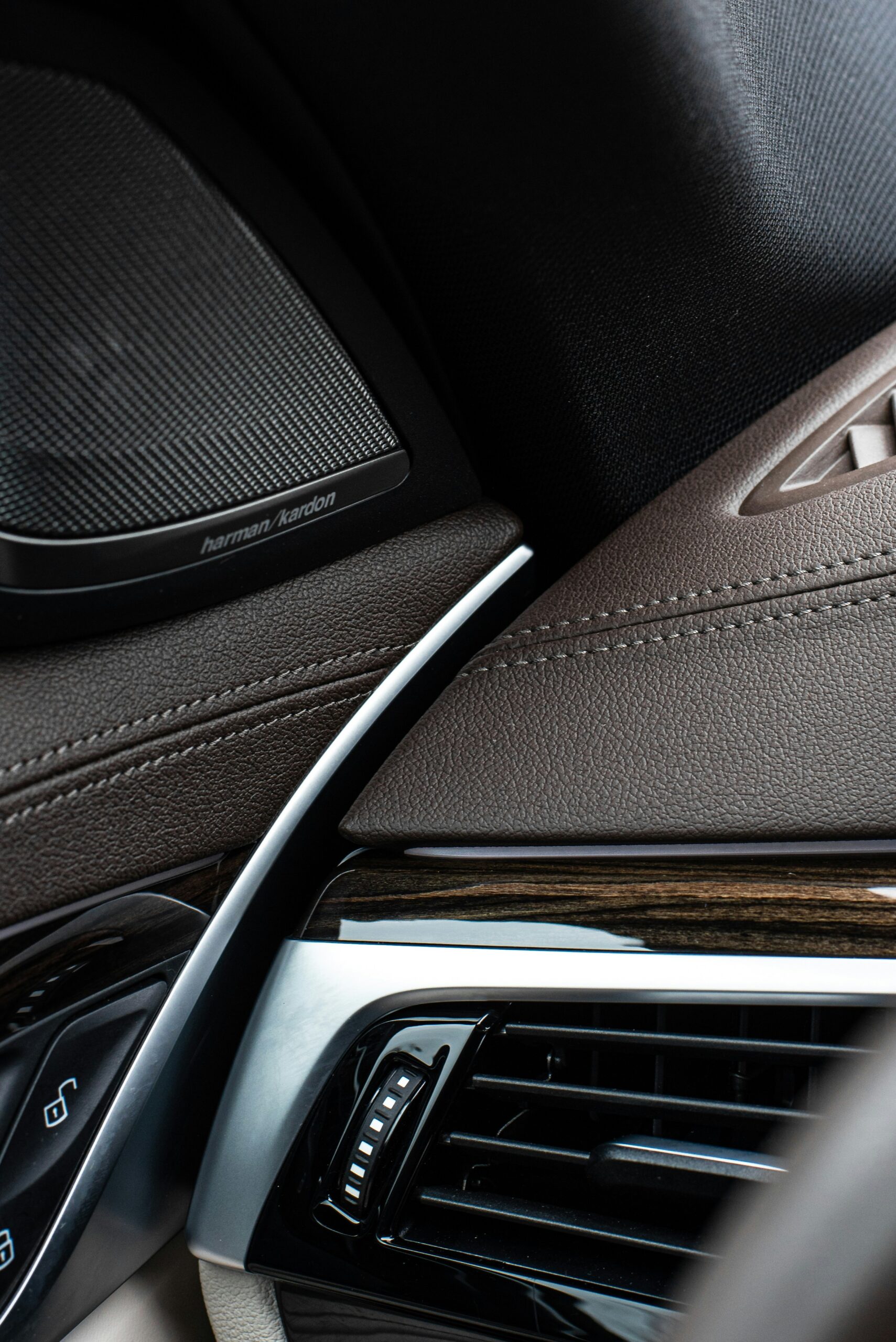 ivan-kazlouskij-Jql9B8C8Kcg-unsplash "Close-up of a car's driver-side dashboard, highlighting air vents and controls often overlooked during routine cleaning."