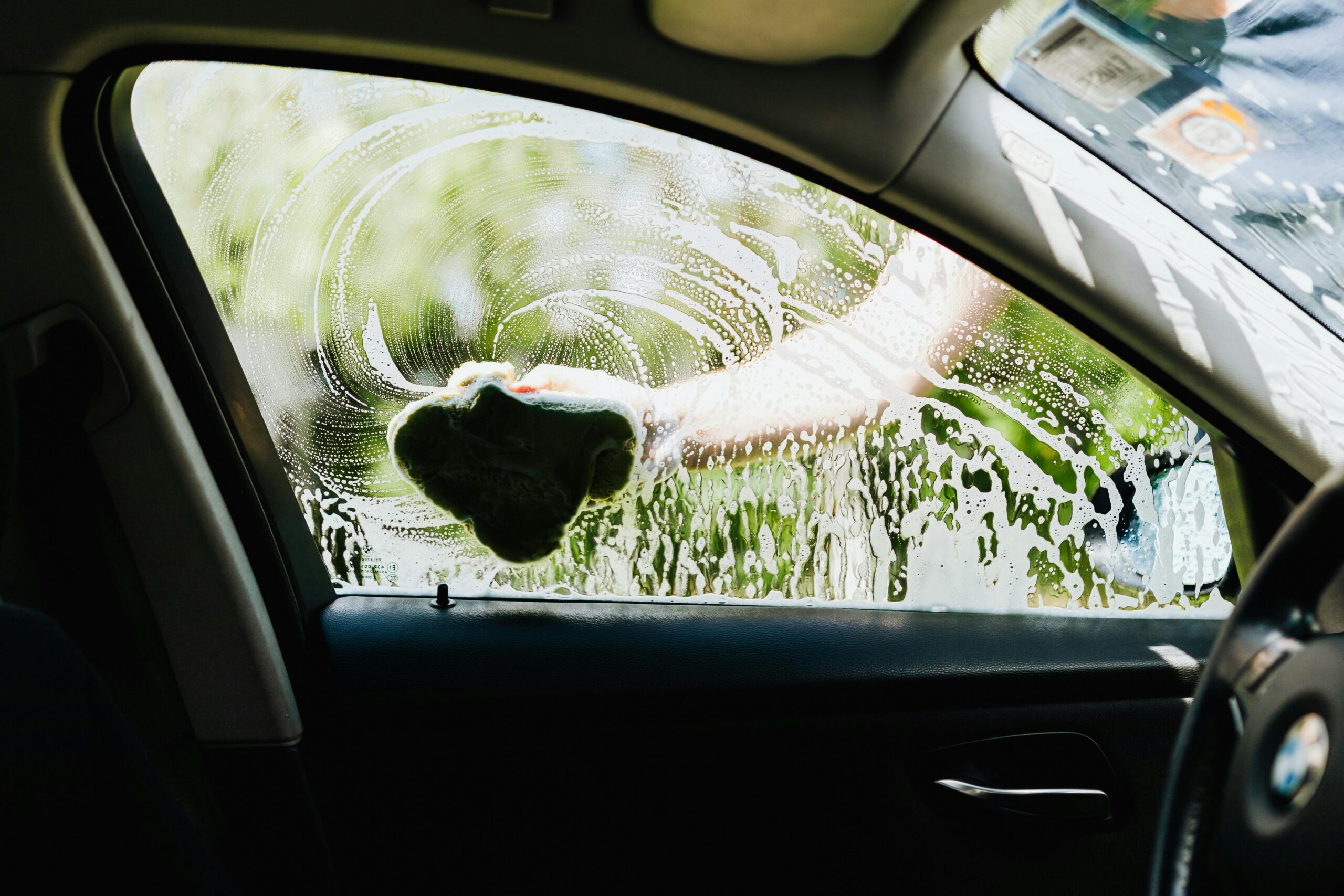 pexels-karolina-grabowska-4870692 "Ceramic coating preparation": A car being hand-washed with a sponge before ceramic coating application.