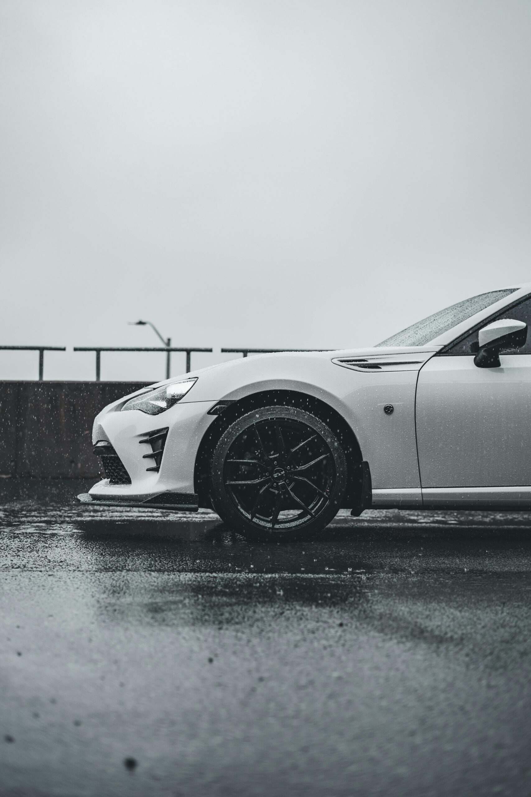 pexels-introspectivedsgn-17792979 Subaru BRZ front half side view in spring rain showing car detailing