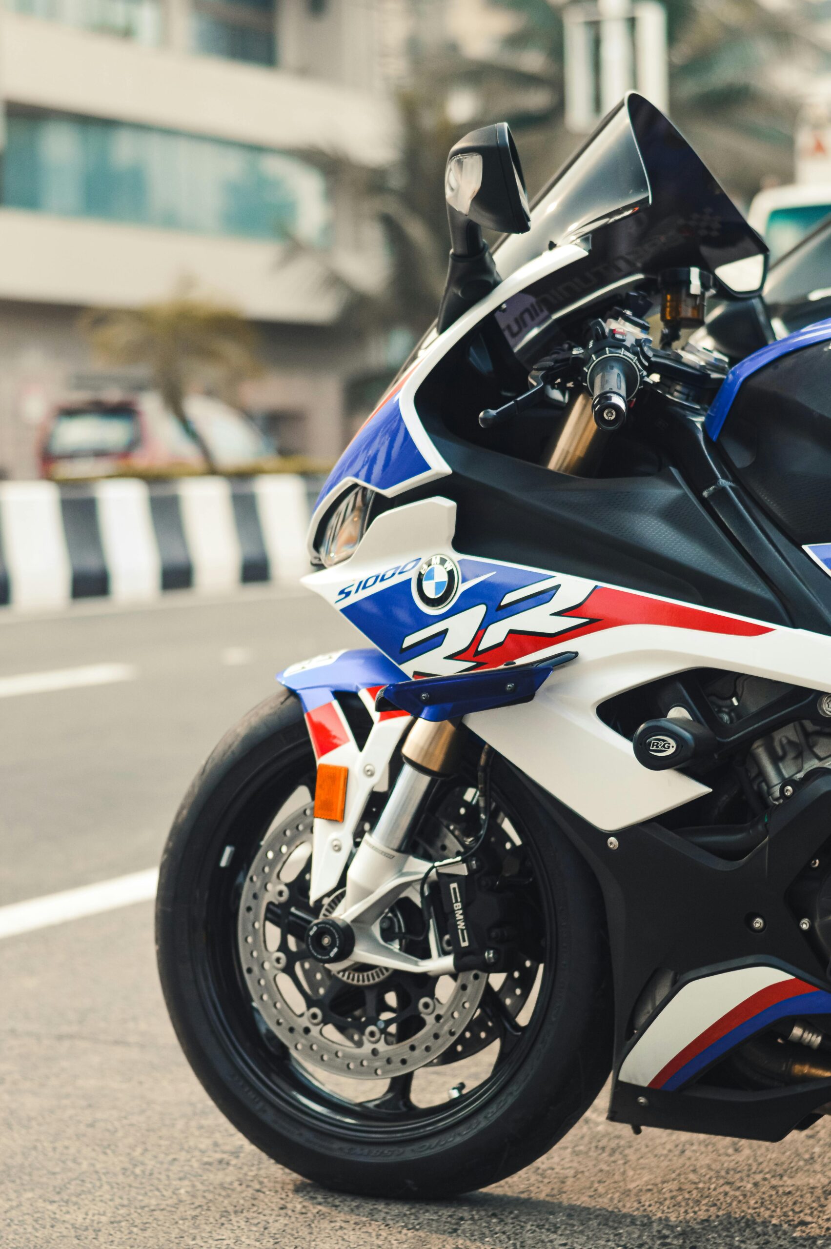pexels-shubham-tekawade-392991834-14765180 Close-up of a BMW S1000RR motorcycle parked on the street, showcasing its sleek design and glossy finish.