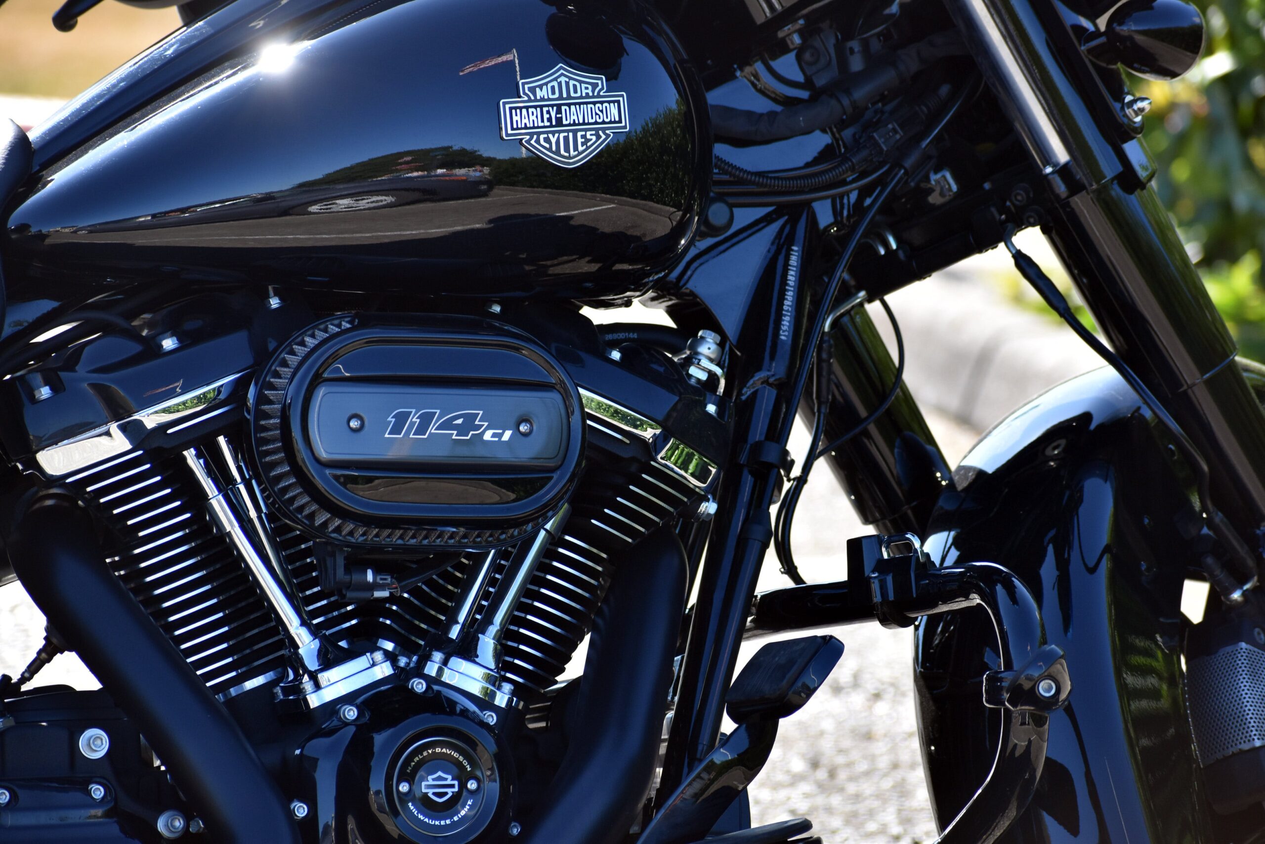 pexels-wr-heustis-310270240-17721855 Glossy black Harley-Davidson motorcycle reflecting the spring sunlight, freshly detailed and polished for the riding season.