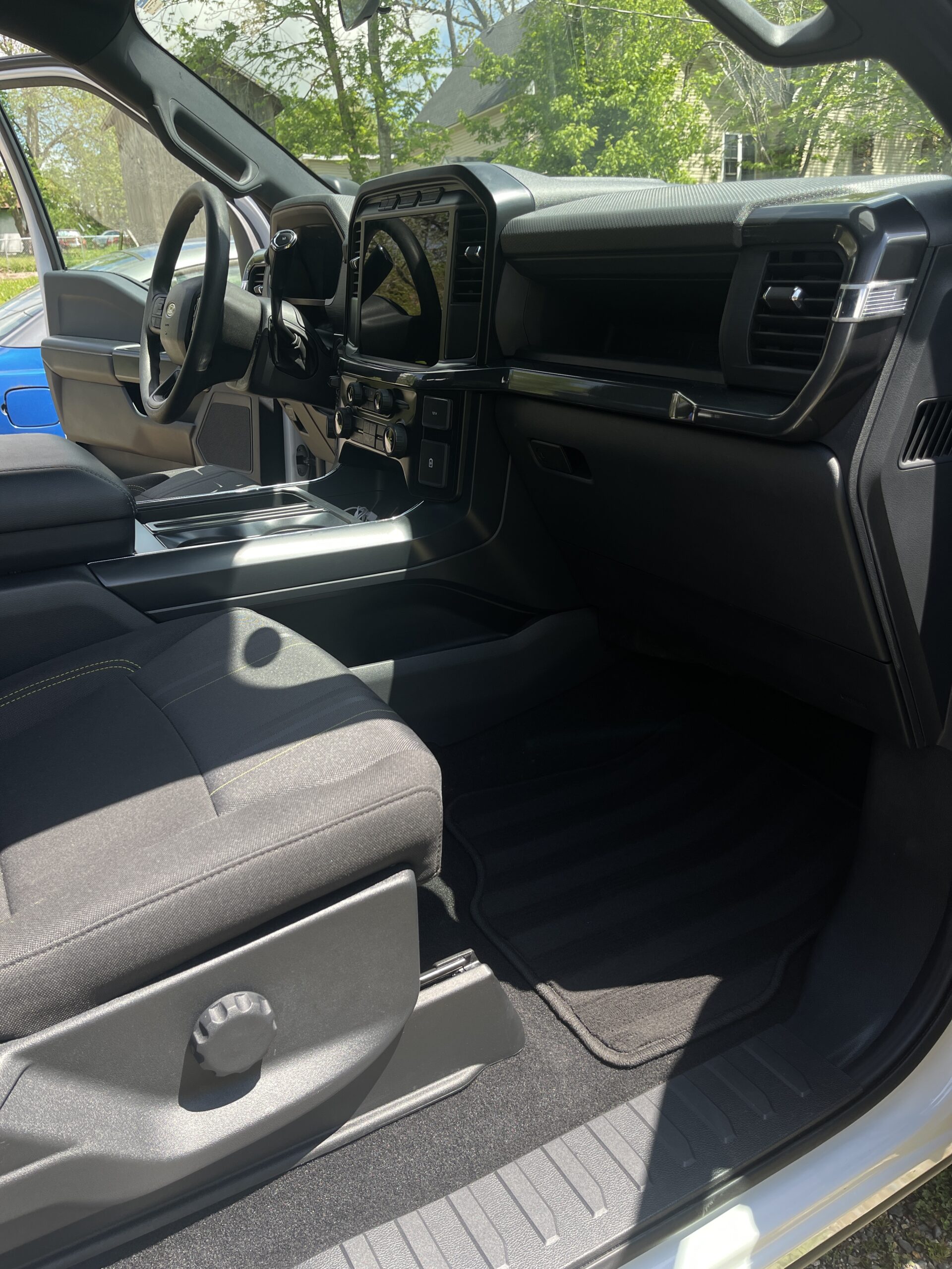 Clean and detailed interior of a pickup truck showcasing spotless dashboard, seats, and floor mats.