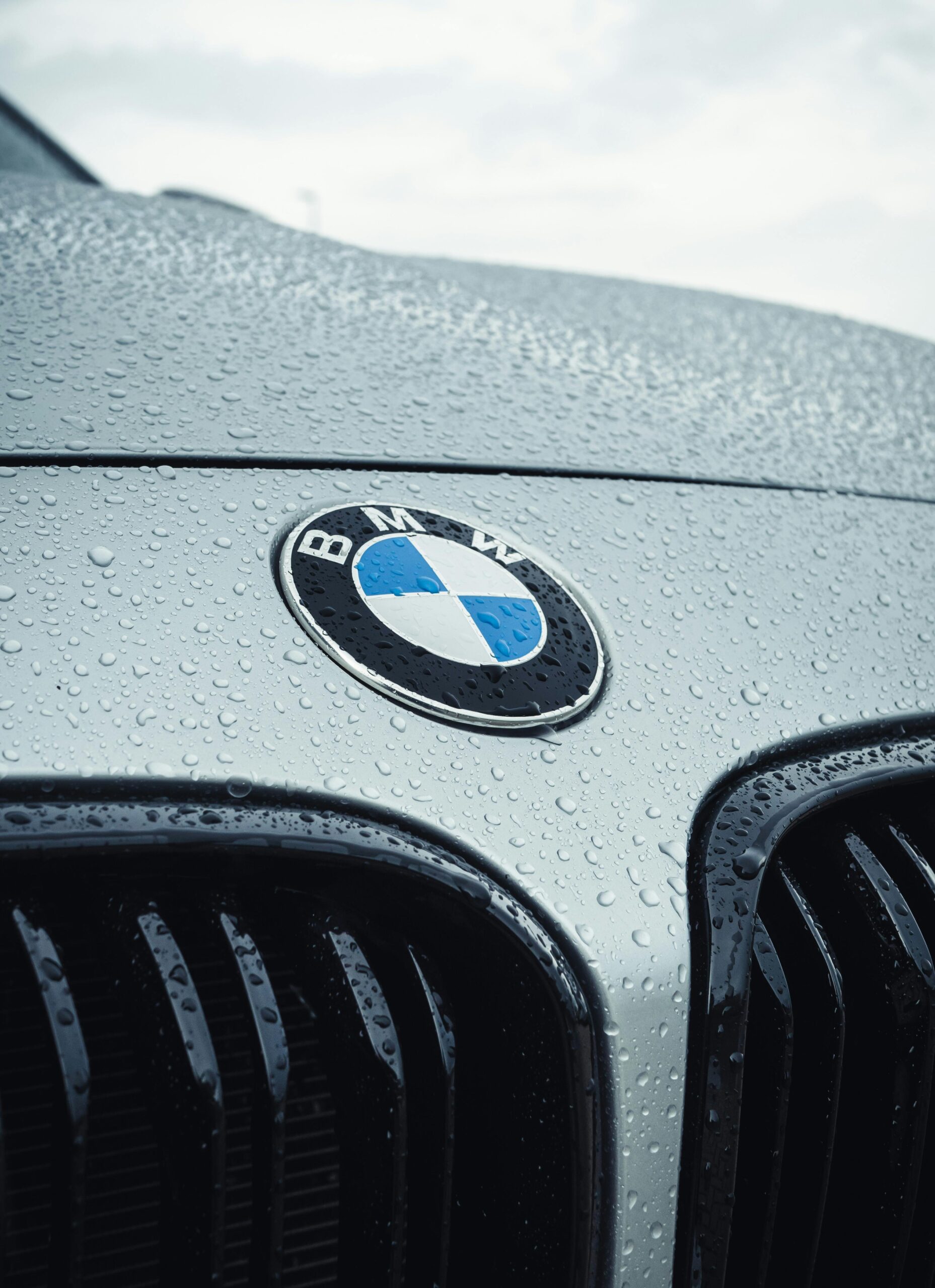 pexels-jarne-aerts-3175149-9050494 Close-up of a freshly detailed BMW hood and grille with water beading on the surface, showing premium car detailing results by Premier Autos Detailing in West Plains, MO.