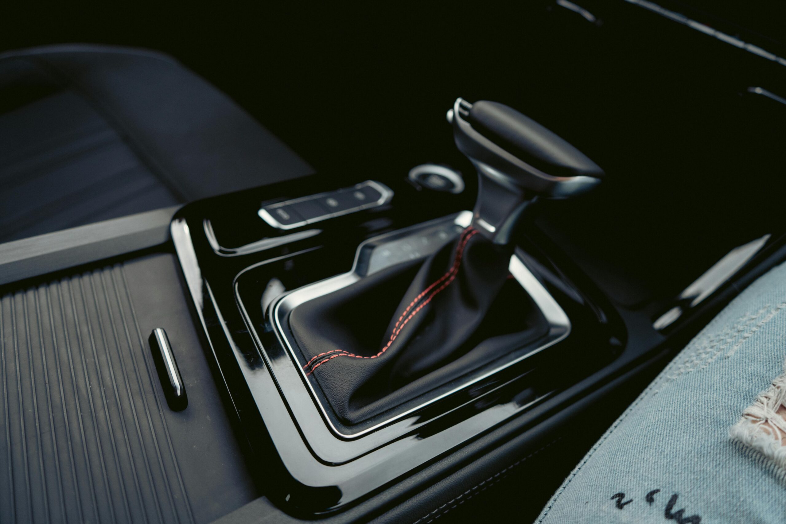 pexels-zhang-guoxin-1343472-2986849 Close-up of a clean car gear shifter with red stitching after professional interior detailing in West Plains, MO